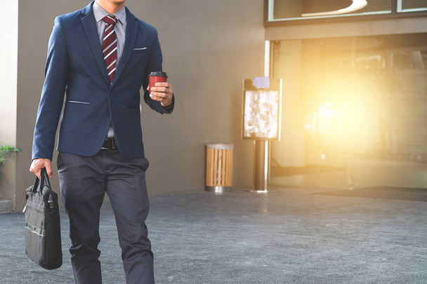 picture of a young business man walking forward with a briefcase - Foto, Imagem