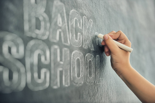 child is writing on blackboard - 写真・画像