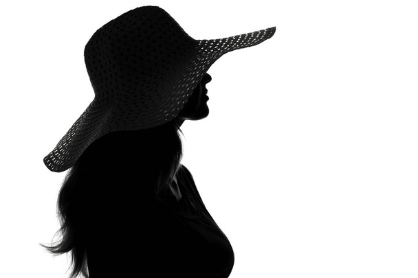 silhouette of a woman in a hat - Фото, изображение