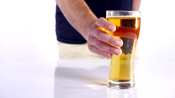 Man with a glass of beer. white background. close up - Materiaali, video