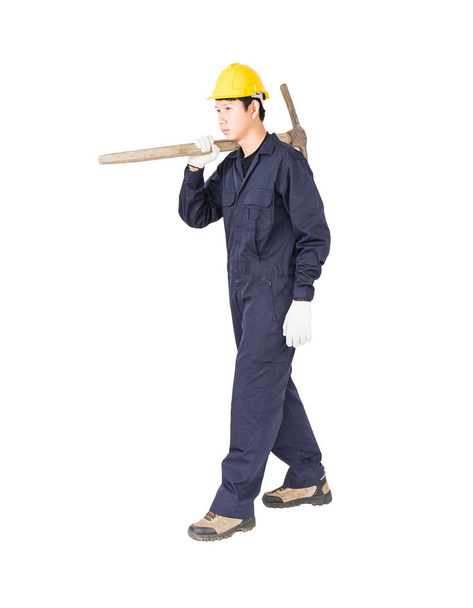 Man in uniform hold old pick mattock that is a mining device - Foto, Imagem