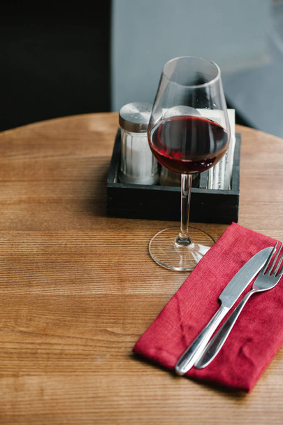 Glass of red wine served on table  - Photo, image