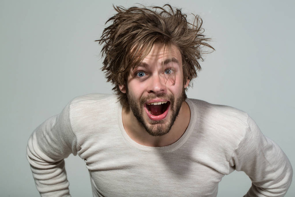 surprised man with long uncombed hair wake up in morning - Фото, зображення