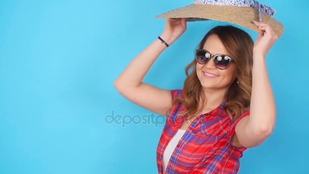 Young woman posing on blue background in studio - Felvétel, videó