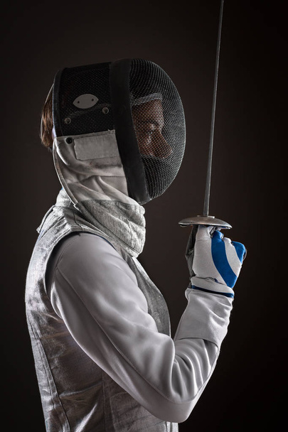 Woman fencer with Mask holding the sword in front of her - Foto, Bild