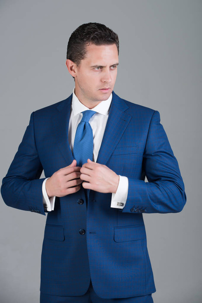 man posing in fashionable blue formal suit with tie - Foto, imagen