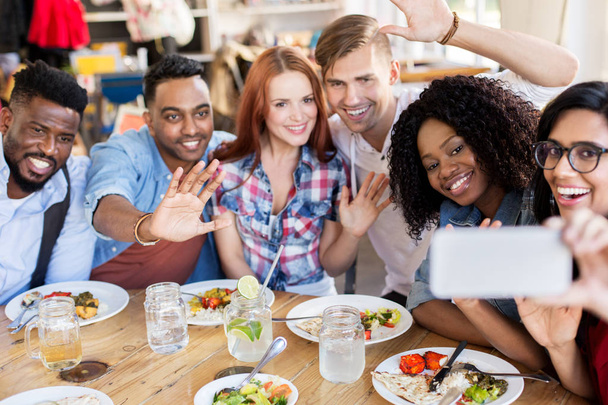 friends eating and taking selfie at restaurant - Valokuva, kuva