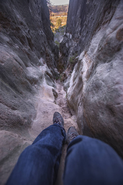 Legs in view of narrow sandstone passage ways - Photo, Image