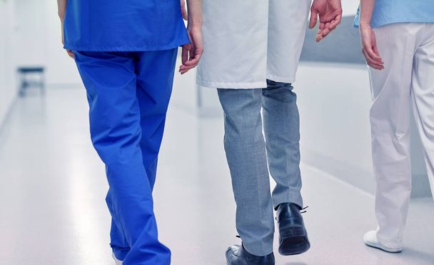 group of medics or doctors walking along hospital - Фото, изображение