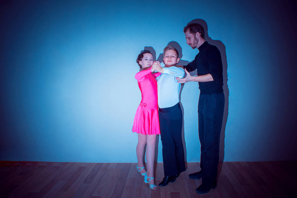 The young boy and girl posing at dance studio - Photo, Image