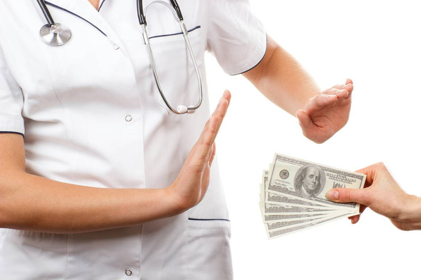 Woman doctor refusing bribes or kickbacks, concept of corruption - Photo, image