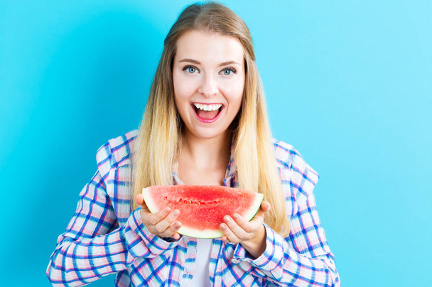 Happy young woman holding watermelon - Foto, imagen