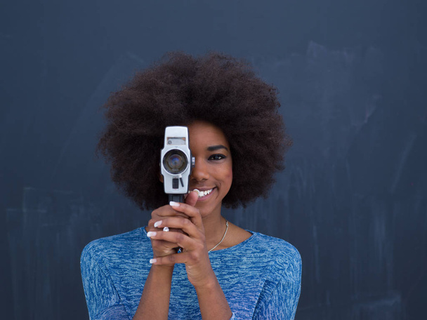 african american woman using a retro video camera - Photo, image