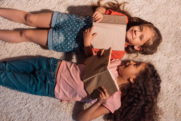multicultural girls lying on floor - Photo, Image