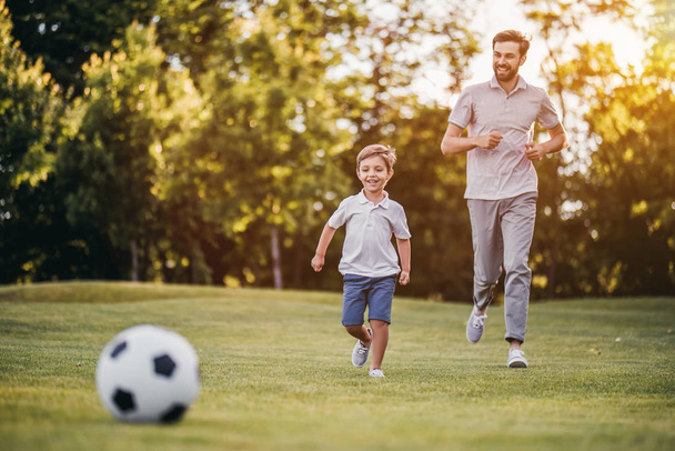 Dad with son playing football - Foto, Bild