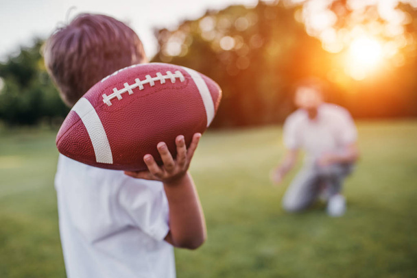 Dad with son playing American football - Foto, Imagen