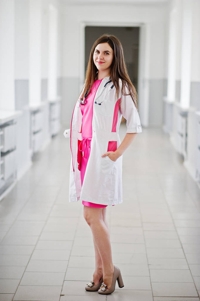 Portrait of a young attractive doctor in white coat with stethos - Photo, Image