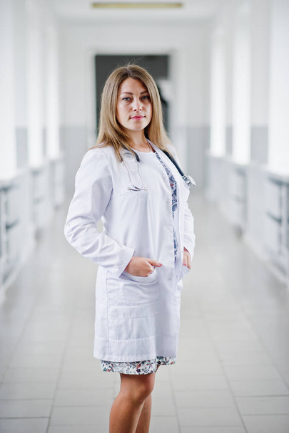 Portrait of a young attractive doctor in white coat with stethos - Fotoğraf, Görsel