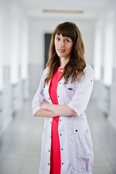 Portrait of a young attractive doctor in white coat with stethos - Photo, Image