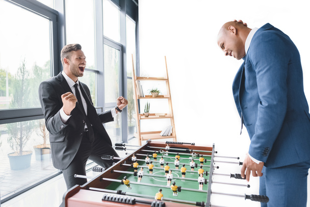 businessmen playing table football - Foto, afbeelding