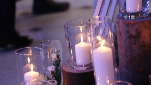 Lighted candles on the floor like decor for the wedding day. Close up dolly shot. View from the side. - Materiał filmowy, wideo