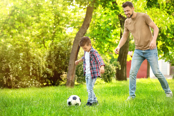 Dad and son playing football  - Фото, зображення