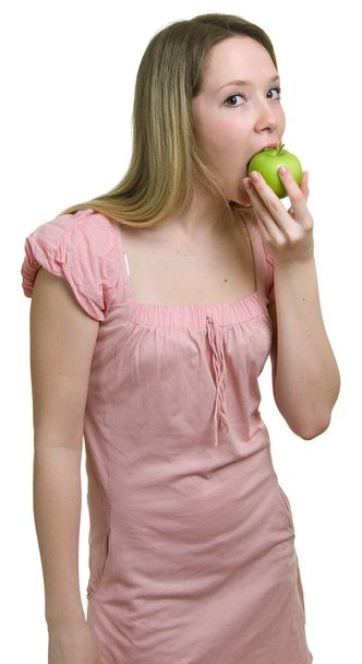 Girl eats a green apple - 写真・画像