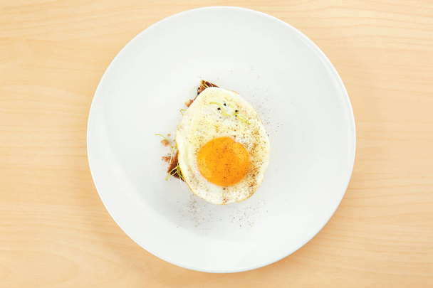 egg and bread slice on wooden background - Fotoğraf, Görsel