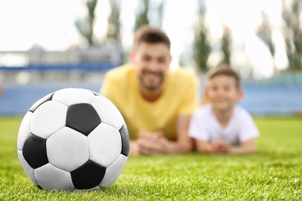 Soccer ball and dad with son   - 写真・画像
