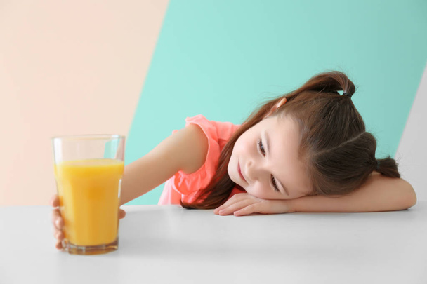 Cute little girl with glass of juice - 写真・画像