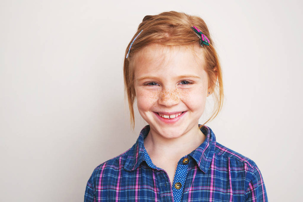 Portrait of happy redhead little girl smiling. - Photo, image