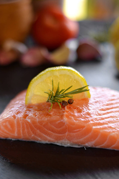 Raw salmon fillets served with lemon - Photo, image