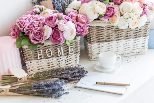 flowers in wicker baskets and notebook - Photo, Image