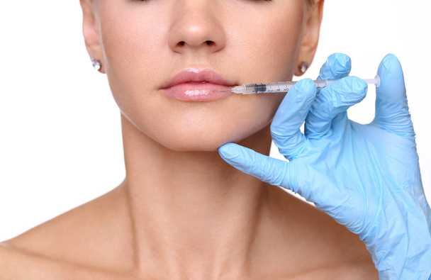 Beautiful woman gets an injection in her lips - Φωτογραφία, εικόνα