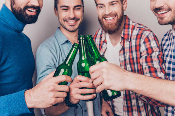 Cheers men! Bachelor men`s life. Low angle cropped photo of four - Фото, зображення