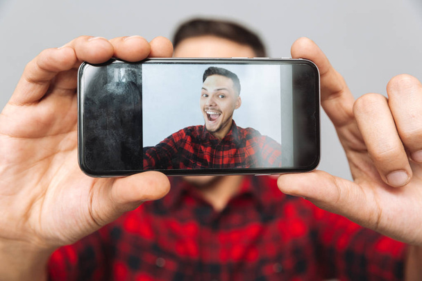 Close up image of man making photo on smartphone - Foto, Bild
