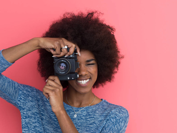 young black girl taking photo on a retro camera - Fotó, kép