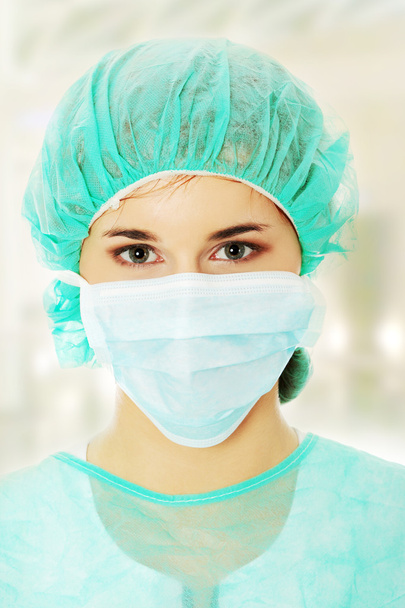 Portrait of serious nurse or doctor in surgical mask - Foto, Imagem