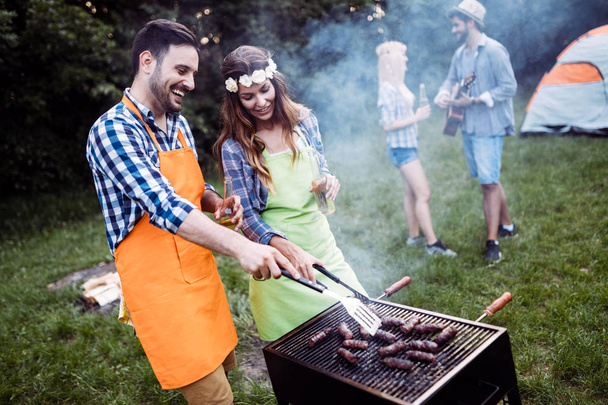 Friends spending time in nature and having barbecue - Фото, изображение