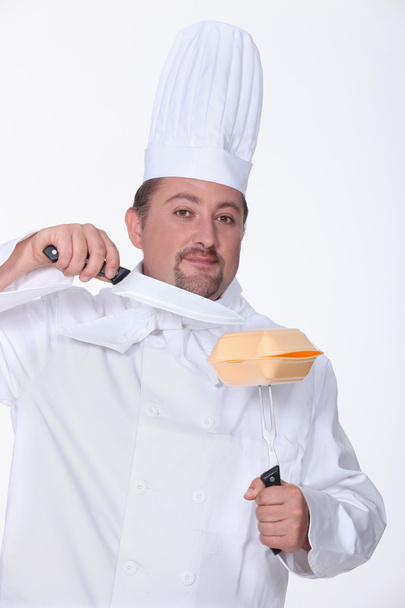 Chef cutting a hamburger box with a big knife - Foto, immagini