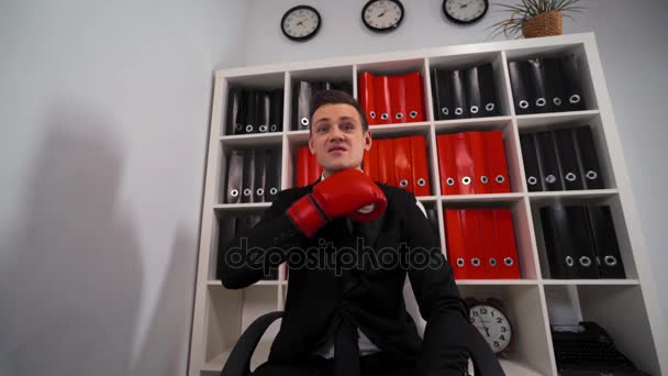 Бизнесмен в боксёрских перчатках угрожает Вам
. - Кадры, видео
