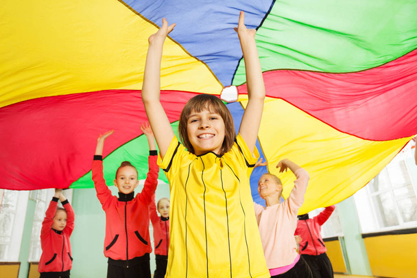 boy and girls playing parachute games - Fotó, kép