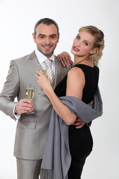 Elegant couple celebrating with champagne on white background - Photo, image