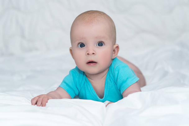 Adorable baby girl or boy in blue shirt with big blue eyes, indo - Фото, зображення