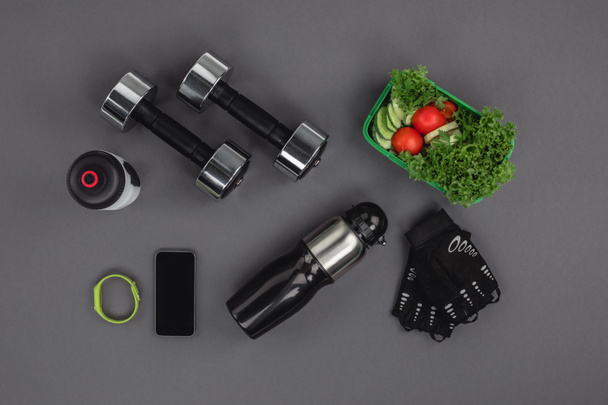 Dumbbells with vegetable salad and gadgets - Valokuva, kuva