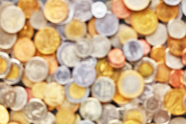 Blurred coins from various countries. - Foto, Imagen