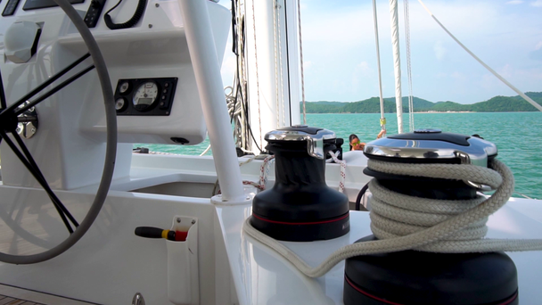 Yacht steering wheel and posing girl at the mast on the background. Sea view. - Footage, Video