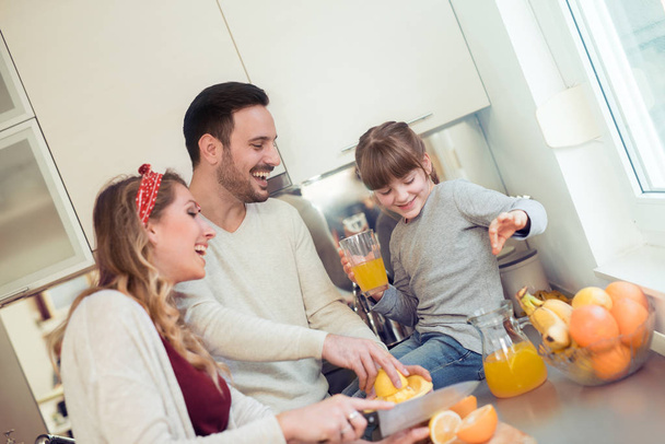 Happy family in the kitchen - Фото, изображение