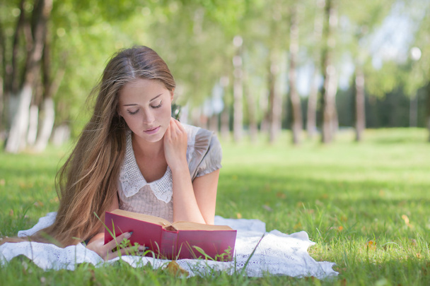 Beautiful girl with book outdoor - Foto, Imagen
