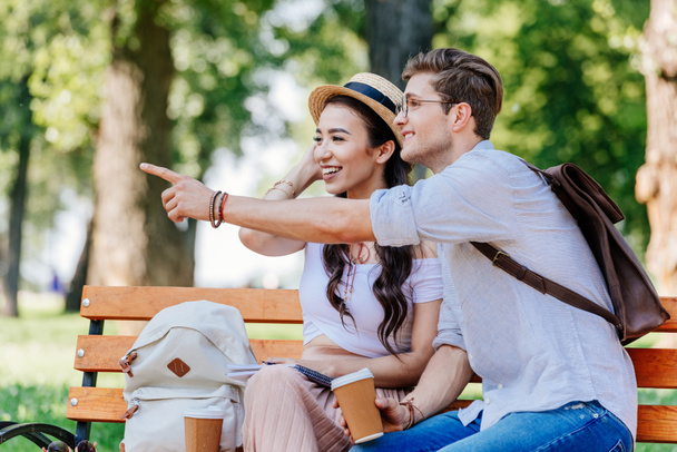 multicultural couple sitting on bench - 写真・画像